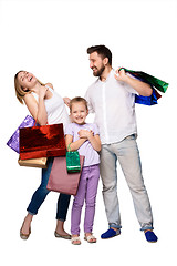 Image showing Happy family with shopping bags standing at studio 