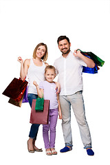 Image showing Happy family with shopping bags standing at studio 