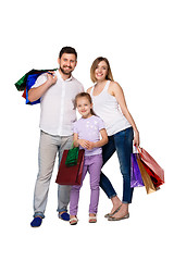 Image showing Happy family with shopping bags standing at studio 