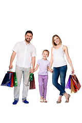 Image showing Happy family with shopping bags standing at studio 