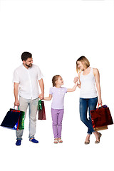 Image showing Happy family with shopping bags standing at studio 