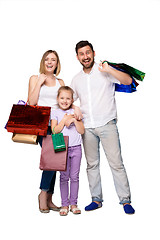 Image showing Happy family with shopping bags standing at studio 