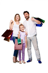 Image showing Happy family with shopping bags standing at studio 