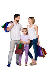 Image showing Happy family with shopping bags standing at studio 