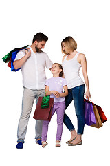 Image showing Happy family with shopping bags standing at studio 