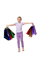 Image showing Happy girl with shopping bags standing at studio 