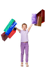 Image showing Happy girl with shopping bags standing at studio 