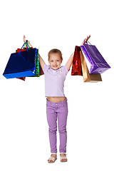 Image showing Happy girl with shopping bags standing at studio 