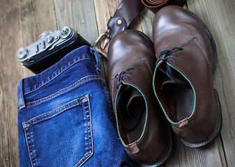 Image showing blue jeans, brown boots, leather belt and rangefinder camera