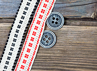 Image showing two old ribbons with embroidered ornaments and vintage buttons