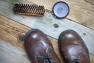 Image showing Still life with brown boots, shoe polish and brush