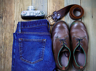 Image showing Still life with rangefinder camera, brown boots, leather belt an