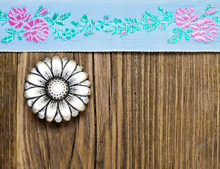 Image showing vintage aqua color tape with embroidered ornaments and old butto