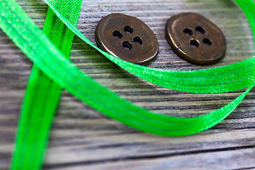 Image showing still life with old green tape and two vintage buttons