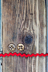 Image showing still life with old red tape and two vintage buttons