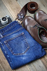 Image showing brown boots, blue jeans, leather belt and rangefinder camera