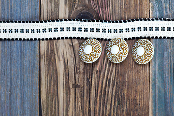 Image showing Vintage tape with embroidered pattern and three ancient buttons