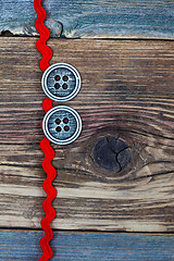 Image showing vintage red tape and two old classic buttons