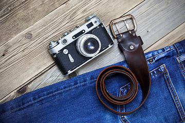 Image showing old blue jeans, vintage leather belt and ancient rangefinder cam