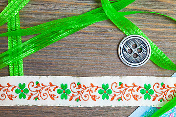 Image showing vintage embroidered band and tape with old classic button