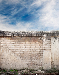 Image showing Blue sky with clouds behind the cracked wall