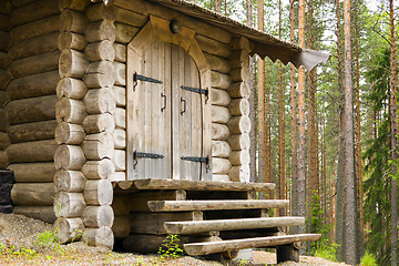 Image showing Entrance door and porch of log house in forest