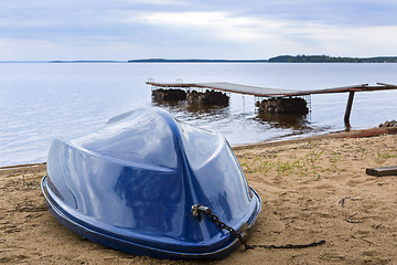 Image showing Boat on wild lake beach