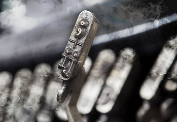 Image showing IJ hammer - old manual typewriter - mystery smoke