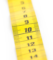 Image showing Yellow measuring tape isolated - selective focus