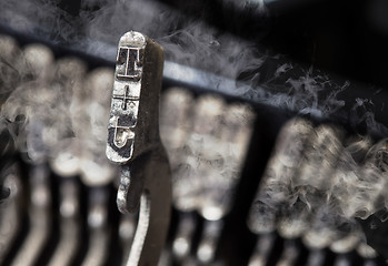 Image showing T hammer - old manual typewriter - mystery smoke