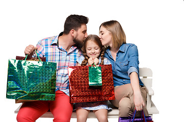 Image showing Happy family with shopping bags sitting at studio 