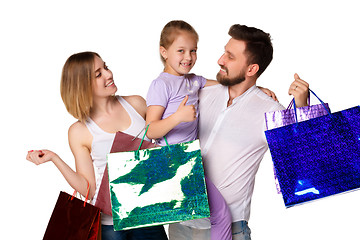 Image showing Happy family with shopping bags standing at studio 