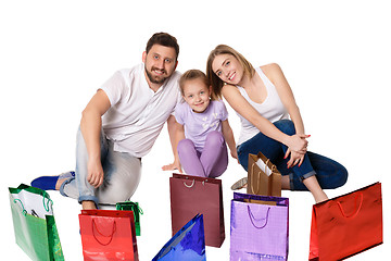 Image showing Happy family with shopping bags sitting at studio 