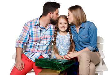 Image showing Happy family with shopping bags sitting at studio 