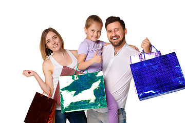 Image showing Happy family with shopping bags standing at studio 