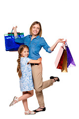 Image showing Happy a mother and daughter with shopping bags standing at studio 