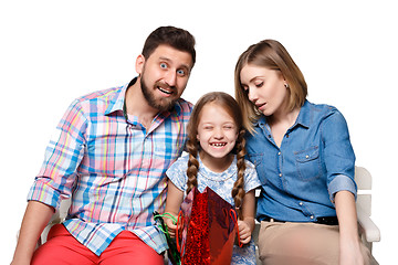 Image showing Happy family with shopping bags sitting at studio 