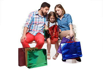 Image showing Happy family with shopping bags sitting at studio 