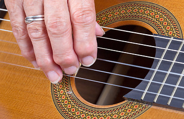 Image showing Old woman\'s hand playing guitar