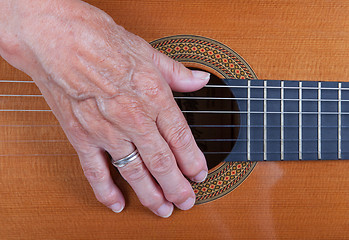 Image showing Old woman\'s hand playing guitar