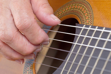 Image showing Old woman\'s hand playing guitar