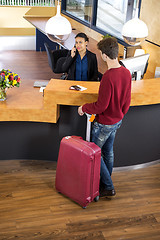 Image showing Man With Luggage At Hotel Reception