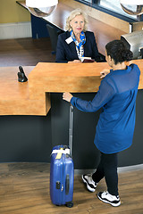 Image showing Woman With Luggage At Hotel Reception