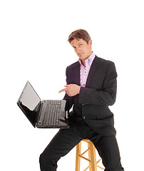 Image showing Business man showing on laptop.