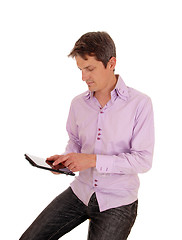 Image showing Man playing with tablet pc.