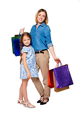 Image showing Happy a mother and daughter with shopping bags standing at studio 