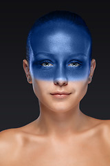 Image showing Portrait of a woman who is posing covered with blue paint