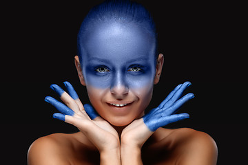 Image showing Portrait of a woman who is posing covered with blue paint