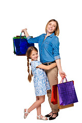 Image showing Happy a mother and daughter with shopping bags standing at studio 