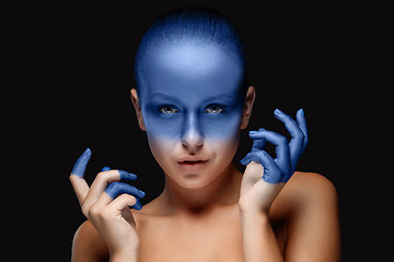 Image showing Portrait of a woman who is posing covered with blue paint